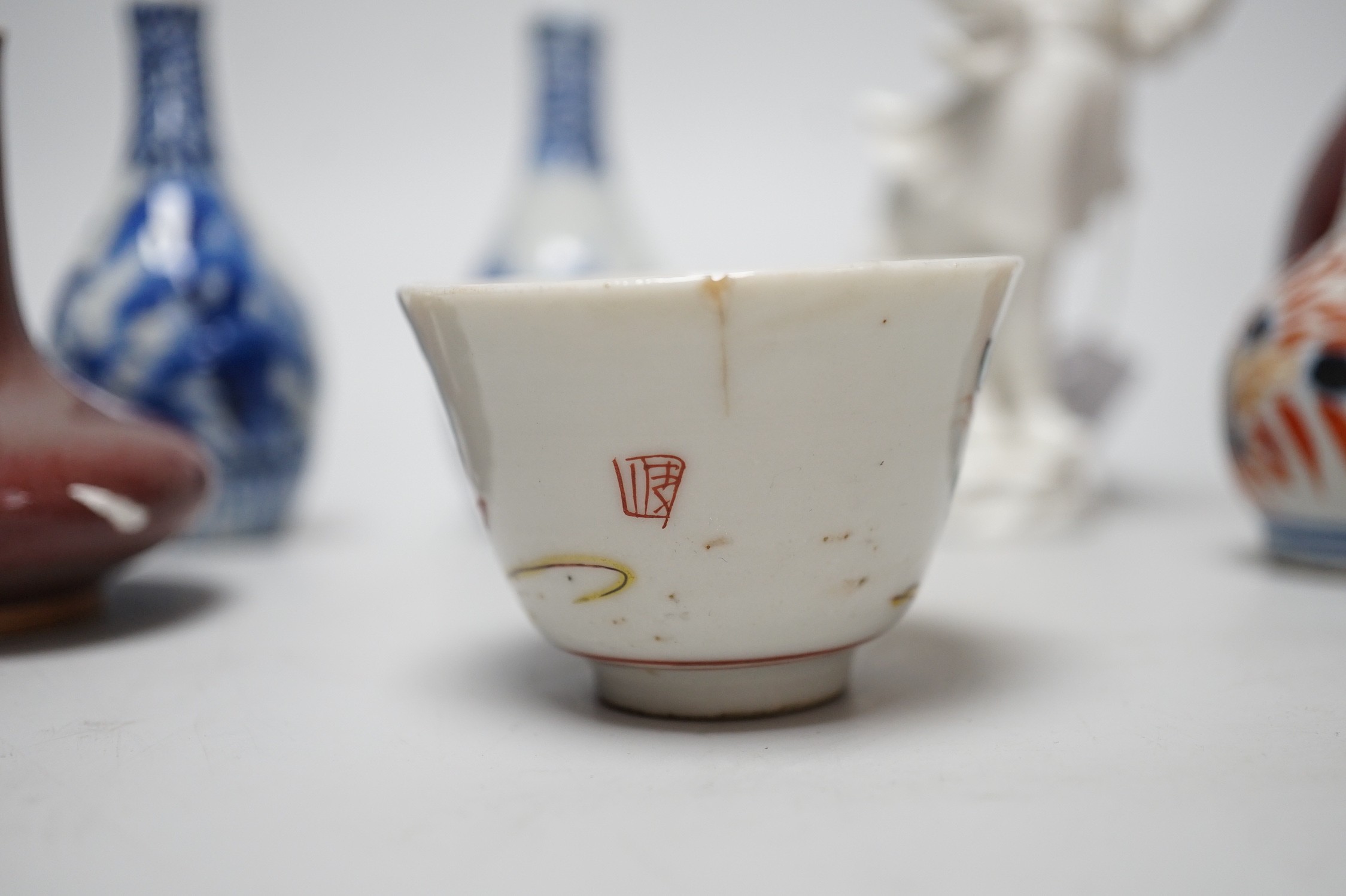 A Chinese sang de boeuf bottle neck vase, together with four Chinese miniature vases, three Chinese figures and a Chinese tea bowl, tallest 15cm